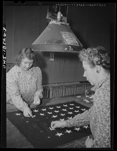 Verona, New Jersey. Sticking stars onto a flag at the Annin Flag Company. They are later sewn on by machine