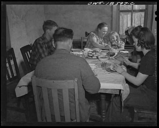 Untitled photo, possibly related to: Moreno Valley, Colfax County, New Mexico. The Mutz family at dinner