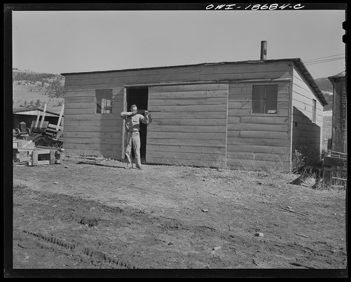 Untitled photo, possibly related to: Moreno Valley, Colfax County, New Mexico. George Turner, a gunsmith as well as a cattleman, checking the bore of a rifle