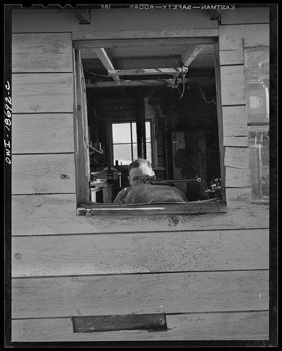Moreno Valley, Colfax County, New Mexico. George Turner, a gunsmith as well as a cattleman, checking the mounting of a telescopic sight on his rifle