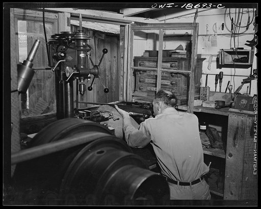 Moreno Valley, Colfax County, New Mexico. George Turner, a gunsmith as well as a cattleman, checking the mounting of a telescopic sight on his rifle