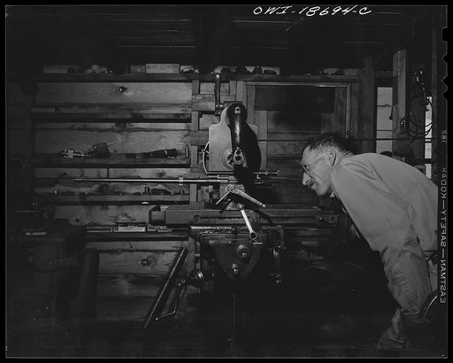 Untitled photo, possibly related to: Moreno Valley, Colfax County, New Mexico. George Turner, a gunsmith as well as a cattleman, checking the mounting of a telescopic sight on his rifle