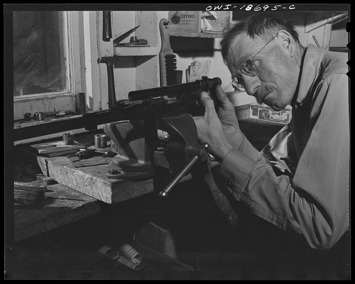 Moreno Valley, Colfax County, New Mexico. George Turner, a gunsmith as well as a cattleman, checking the mounting of a telescopic sight on his rifle