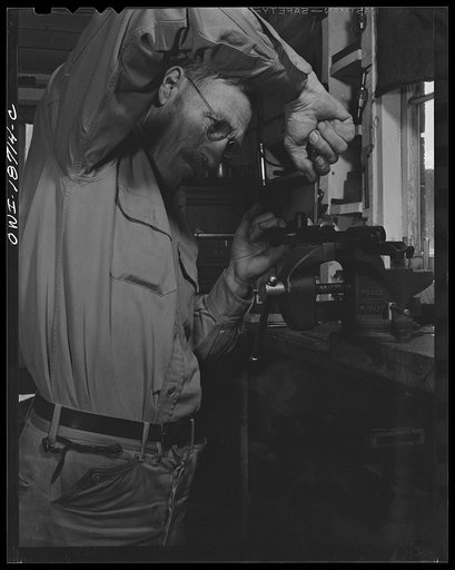 Untitled photo, possibly related to: Moreno Valley, Colfax County, New Mexico. George Turner, a gunsmith as well as a cattleman, working in his shop