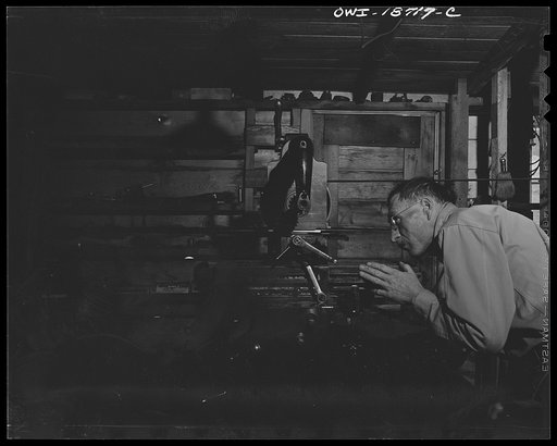 Untitled photo, possibly related to: Moreno Valley, Colfax County, New Mexico. George Turner, a gunsmith as well as a cattleman, working in his shop