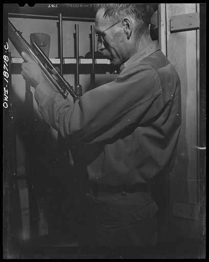 Untitled photo, possibly related to: Moreno Valley, Colfax County, New Mexico. George Turner, a gunsmith as well as a cattleman, working in his shop