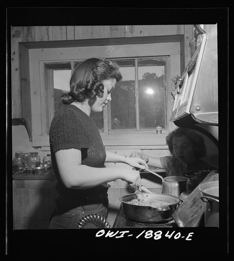 Untitled photo, possibly related to: Moreno Valley, Colfax County, New Mexico. The older daughter preparing dinner on George Mutz's farm
