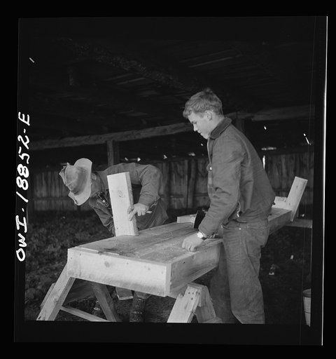 Untitled photo, possibly related to: Moreno Valley, Colfax County, New Mexico. George Mutz and his son building a feed trough