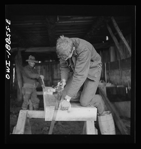 Untitled photo, possibly related to: Moreno Valley, Colfax County, New Mexico. George Mutz and his son building a feed trough