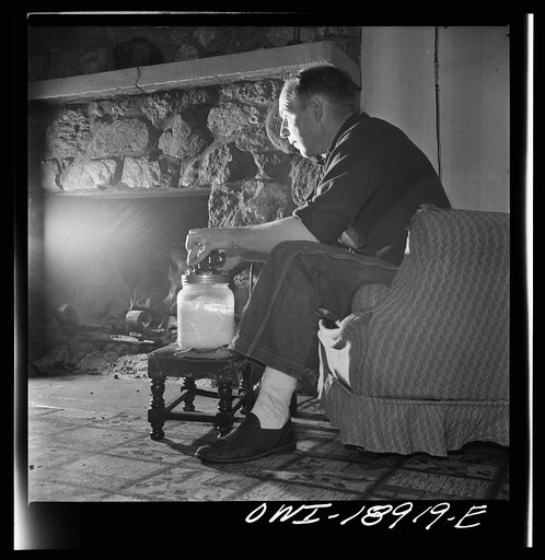 Untitled photo, possibly related to: Moreno Valley, Colfax County, New Mexico. William Heck, a stockman, churning butter after a hard day in the saddle