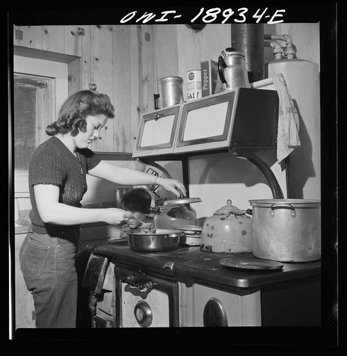 Moreno Valley, Colfax County, New Mexico. The older daughter preparing dinner on George Mutz's farm
