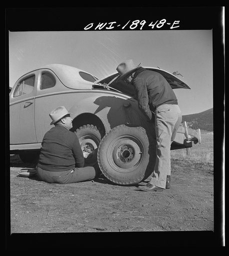 Moreno Valley, Colfax County, New Mexico. George Turner changing a tire