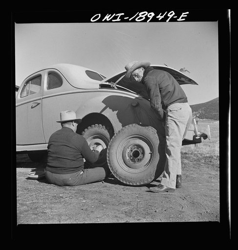 Moreno Valley, Colfax County, New Mexico. George Turner changes a tire