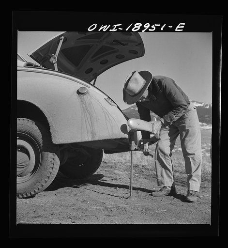 Moreno Valley, Colfax County, New Mexico. George Turner changing a tire