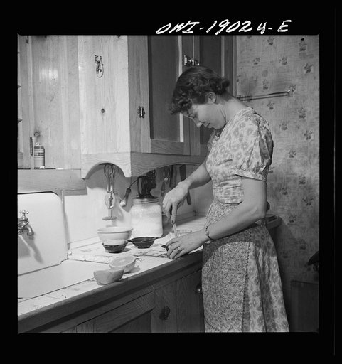 Untitled photo, possibly related to: Moreno Valley, Colfax County, New Mexico. William Heck's wife getting supper