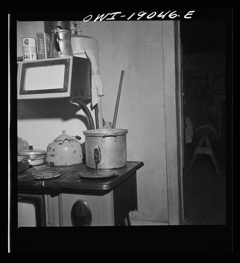 Untitled photo, possibly related to: Moreno Valley, Colfax County, New Mexico. The older daughter preparing dinner on George Mutz's farm