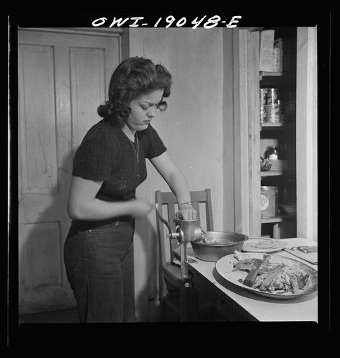 Moreno Valley, Colfax County, New Mexico. George Mutz's daughter grinding meat on the ranch