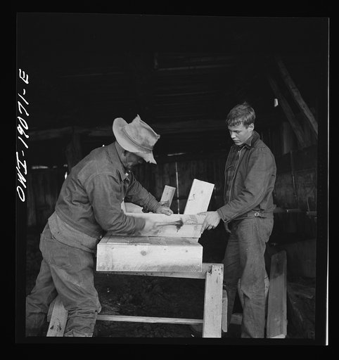 Untitled photo, possibly related to: Moreno Valley, Colfax County, New Mexico. George Mutz and his son building a feed trough