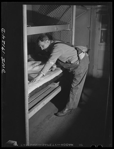 Fort Madison, Iowa. Atchison, Topeka and Santa Fe Railroad conductor R. Byers of Chillicothe, Illinois, preparing to spend the night in a caboose at the end of a day's run