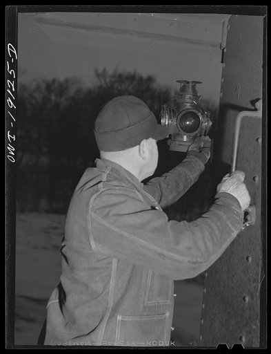 As darkness falls, the brakeman hangs out the markers on the caboose on the route to Fort Madison, Iowa