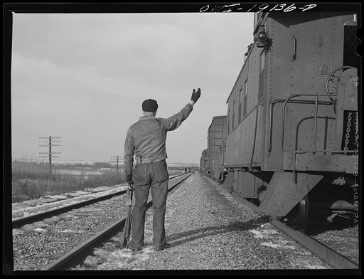 Atchison, Topeka and Santa Fe train waiting in a siding for a passenger train to pass enroute to Fort Madison, Iowa