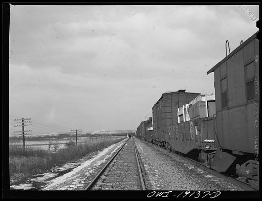 Atchison, Topeka and Santa Fe train waiting in a siding for a passenger train to pass enroute to Fort Madison, Iowa