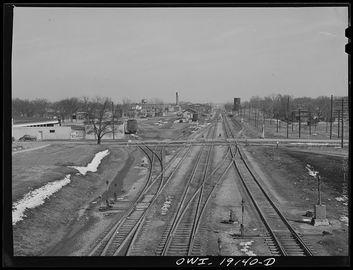 Main line tracks and a town along the tracks of the Atchison, Topeka and Santa Fe Railroad. Marceline, Missouri