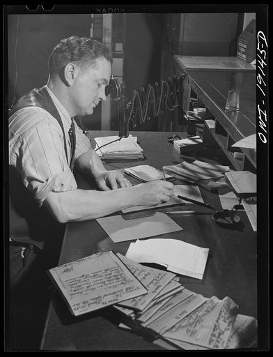 Argentine, near Kansas City, Kansas. Writing train orders in the telegraph room of the Atchison, Topeka and Santa Fe Railroad offices