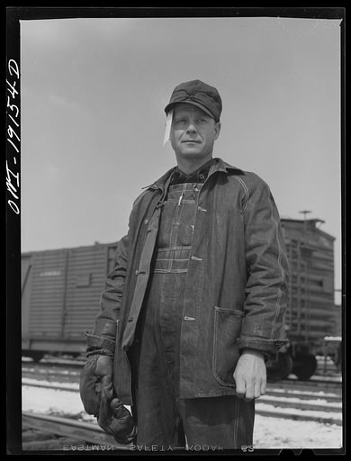 Argentine, near Kansas City, Kansas. Floyd C. McKillip, switchman, in the Atchison, Topeka and Santa Fe Railway yards. The paper stuck in his cap is a switch list