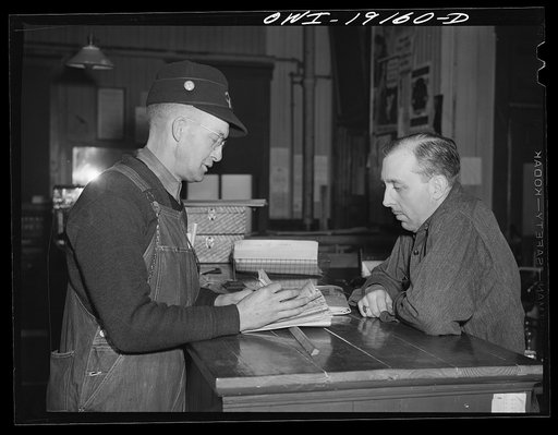 Chicago, Illinois. Atchison, Topeka and Santa Fe Railroad conductor George E. Burton getting his waybills at the Corwith Railroad yard offices