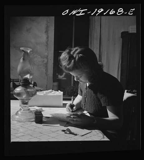 Moreno Valley, Colfax County, New Mexico. Mary Mutz on the ranch writing to a boyfriend in the United States Army