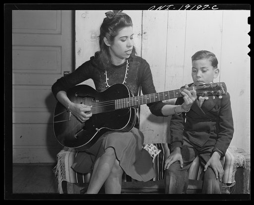 Albuquerque, New Mexico. Spanish-American girl singing folk songs to her little brothers and sisters