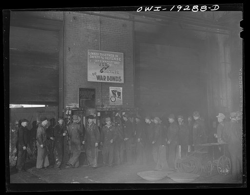 Untitled photo, possibly related to: Topeka, Kansas. Workmen checking out for lunch at the Atchison, Topeka and Santa Fe Railroad locomotive shops