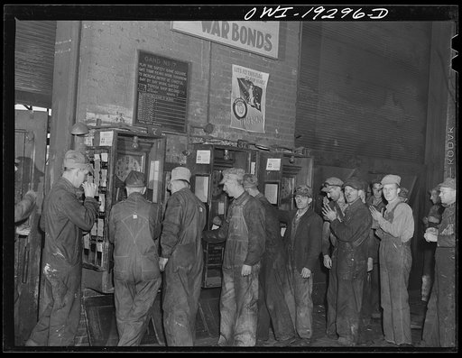 Topeka, Kansas. Workmen checking out for lunch at the Atchison, Topeka and Santa Fe Railroad locomotive shops