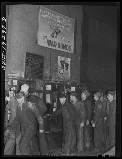 Topeka, Kansas. Workmen checking out for lunch at the Atchison, Topeka and Santa Fe Railroad locomotive shops