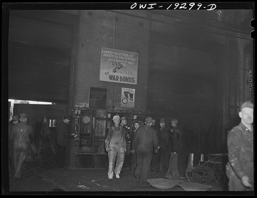 Topeka, Kansas. Workmen checking out for lunch at the Atchison, Topeka and Santa Fe Railroad locomotive shops