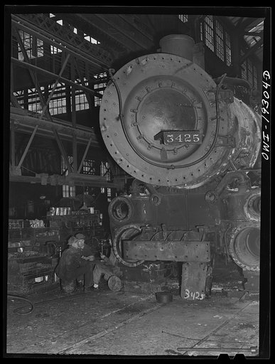 Topeka, Kansas. Workmen in the Atchison, Topeka and Santa Fe Railroad locomotive shops having a game of cards during lunch period