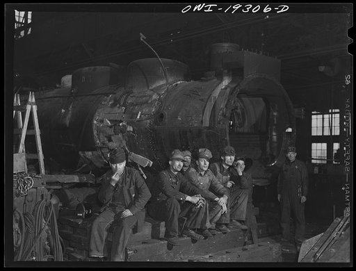 Topeka, Kansas. Workmen in the Atchison, Topeka and Santa Fe Railroad locomotive shops resting during lunch period