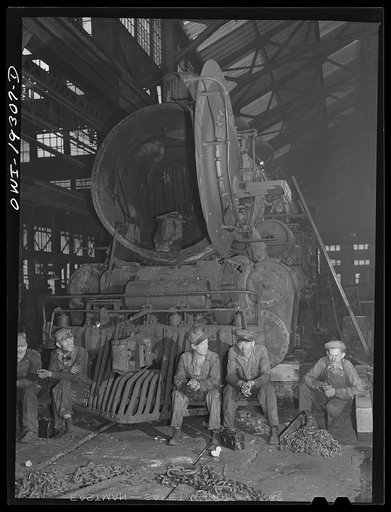 Topeka, Kansas. Workmen in the Atchison, Topeka and Santa Fe Railroad locomotive shops resting during lunch period