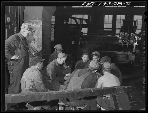 Topeka, Kansas. Workmen in the Atchison, Topeka and Santa Fe Railroad locomotive shops having a game of cards during lunch period