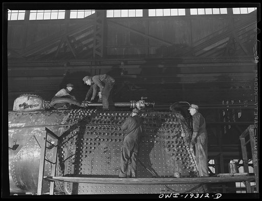 Topeka, Kansas. Working on the fire box end of an engine in the Atchison, Topeka and Santa Fe Railroad locomotive shop