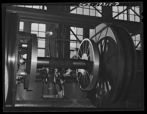 Topeka, Kansas. Preparing driver wheels for re-tiring at the Atchison, Topeka and Santa Fe Railroad wheel shop