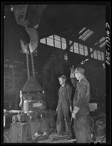 Topeka, Kansas. Raising the air pump of a locomotive at the Atchison, Topeka and Santa Fe Railroad locomotive shops
