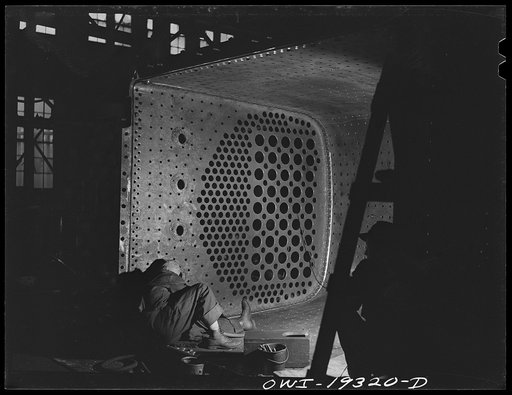 Topeka, Kansas. Welder working on a fire box of an engine in the Atchison, Topeka and Santa Fe Railroad locomotive shops