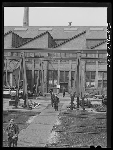 Topeka, Kansas. Workmen coming out of the Atchison, Topeka and Santa Fe Railroad locomotive shops during lunch period