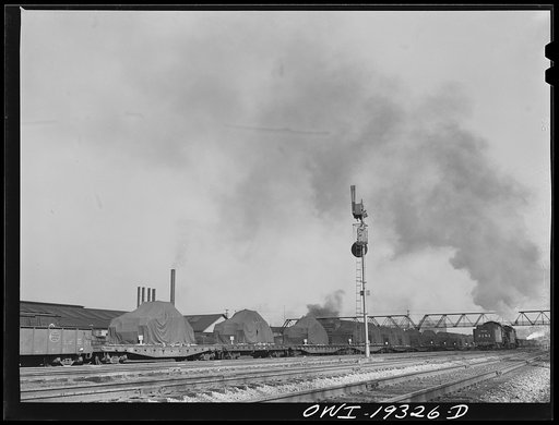 Untitled photo, possibly related to: Kansas City, Kansas. Military tanks on their way through the Atchison, Topeka and Santa Fe Railroad yard