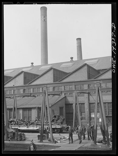 Topeka, Kansas. Workmen coming out of the Atchison, Topeka and Santa Fe Railroad locomotive shops during lunch period