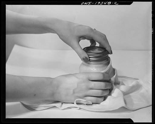 Steel-saving glass-top jars recommended by the War Production Board, Containers Division, for home canning of the Victory garden fruits and vegetables in 1943. Third step is to allow expanding air inside the jar to escape during the processing; the screw band should be turned as far as it will go an