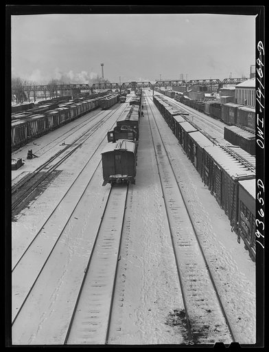 Kansas City, Kansas. Train inspectors working on an Atchison, Topeka and Santa Fe Railroad train
