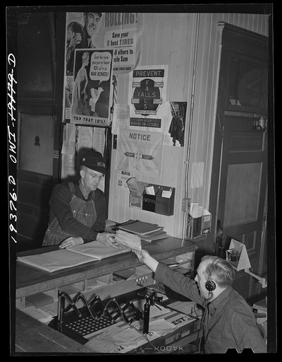 Chicago, Illinois. Atchison, Topeka and Santa Fe Railroad conductor, George E. Burton, getting his train orders at Corwith Yard before leaving for Chillicothe, Illinois
